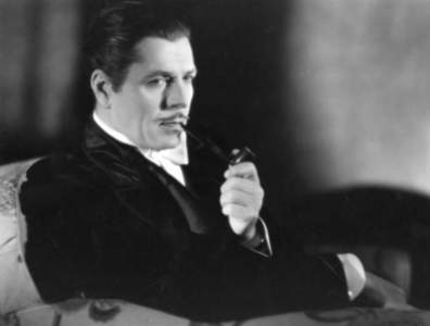 Warner Baxter epitomizes the look with pipe